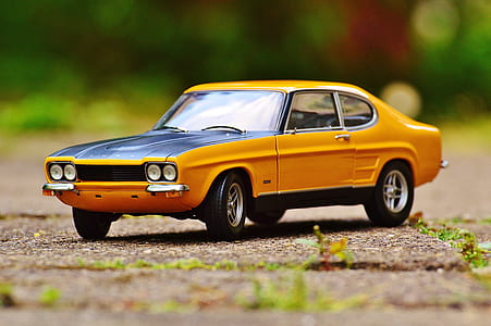 selective focus photo of classic yellow coupe scale model thumbnail
