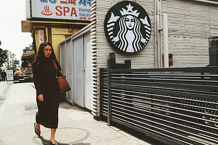 woman walking near Starbucks store thumbnail