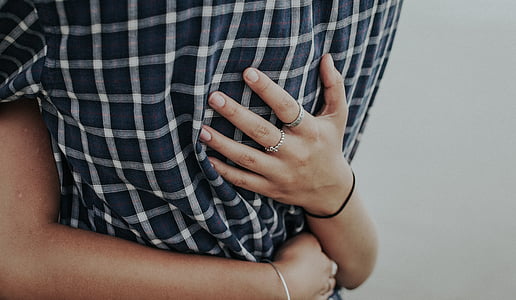 selective focus photography of persons hugging each other thumbnail