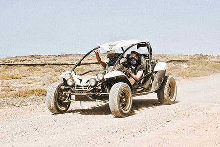 two men riding on dune buggy thumbnail