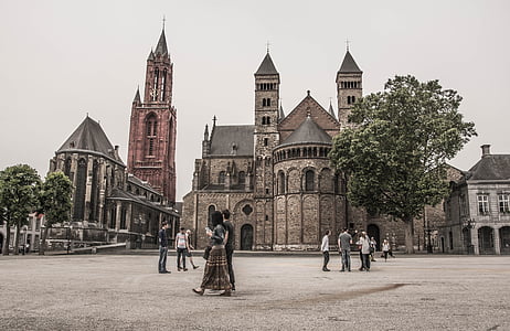 people walking beside cathedral during daytime thumbnail