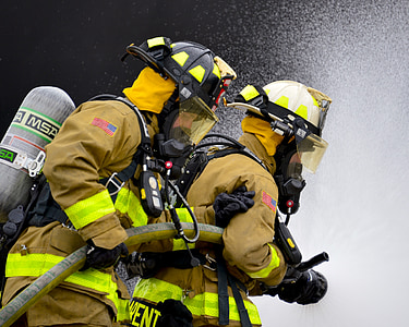 two firefighter carrying fire hose thumbnail