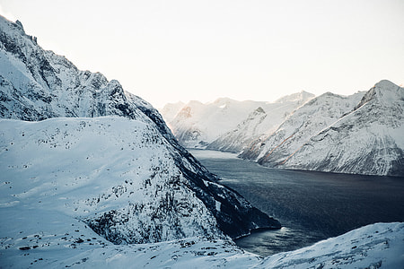 blue lake between mountains covered in snow at daytime screenshot thumbnail