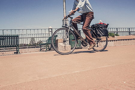 man riding on bicycle near park bench thumbnail