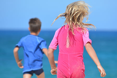 selective focus photo of girl and boy on seashore thumbnail