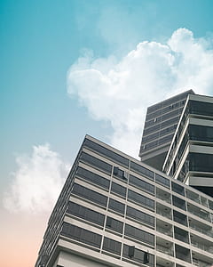 low angle-view photography of high rise building under blue sky thumbnail