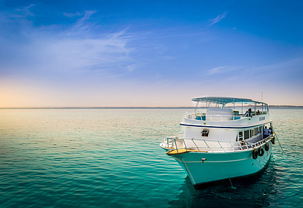 blue and white yacht on blue body of water thumbnail