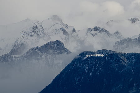 snow capped mountain covered with fogs thumbnail