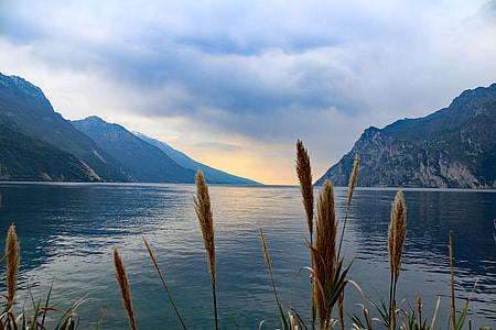 photo of blue body of water and mountain at daytime thumbnail