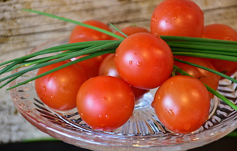 orange tomatoes on round glass plate thumbnail