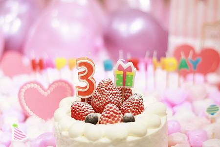 white cake with strawberries on top thumbnail