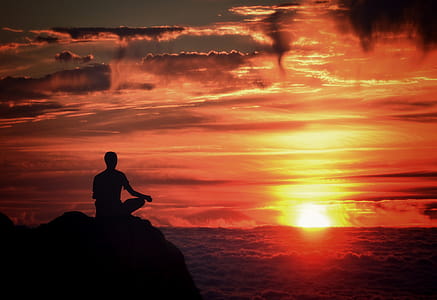 Meditation - Mindfulness - Person Meditating at Sunset Over the Clouds thumbnail