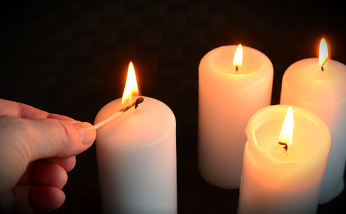 four lighted pillar candles thumbnail