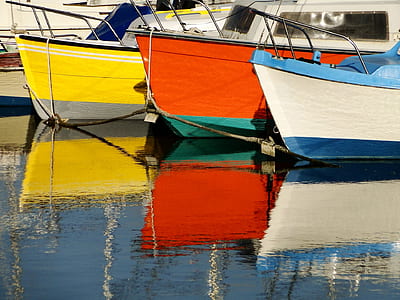 photo of assorted-color boats in body of water thumbnail