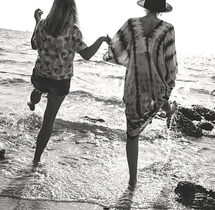 two women standing at seashore thumbnail