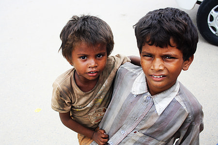 boy carrying boy near car thumbnail