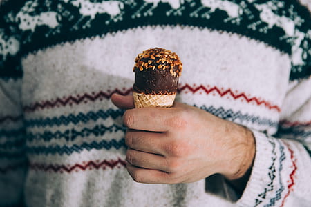 person's hand holding an ice cream thumbnail
