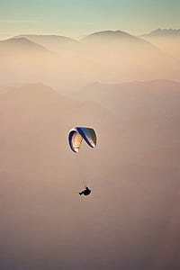 person gliding parachute during day time thumbnail