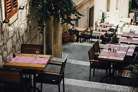 brown wooden tables along the street during daytime thumbnail