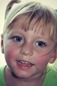 toddler with blue-eyes wearing green crew-neck top thumbnail