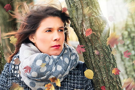 woman standing beside tree thumbnail