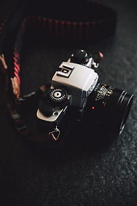 selective focus photography of black and gray DSLR camera thumbnail