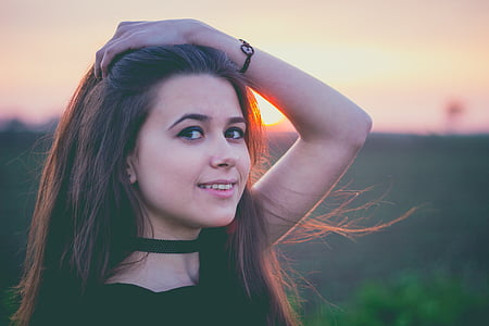 selective focus photography of woman wearing black top during dusk thumbnail