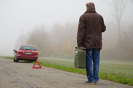person standing holding gasoline container thumbnail