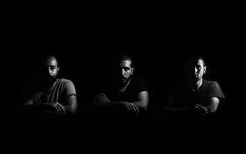 grayscale photography of three man sitting thumbnail