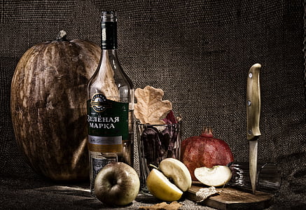 labeled liquor bottle near variety of fruits thumbnail