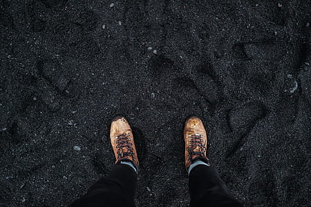 person stepping on black sand thumbnail
