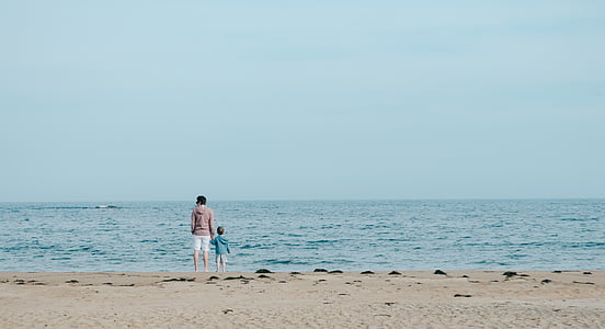 man and children facing body of water thumbnail