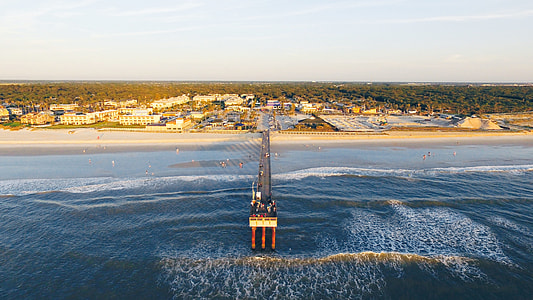 aerial photography of gray and white dock towards seashore thumbnail