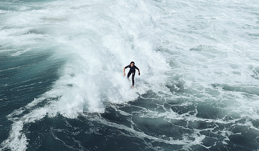 man surfing during daytime thumbnail