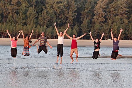 group of people jumpshot on the body of water thumbnail