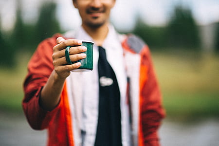 person holding green mug thumbnail