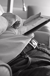 grayscale photo of man holding table computer thumbnail