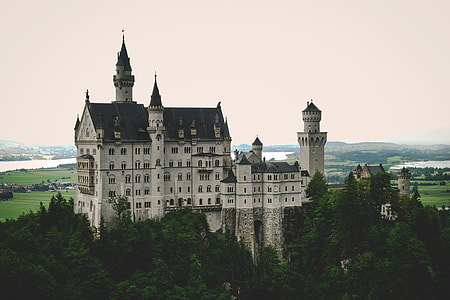 white and black concrete castle under cloudy sky during daytime thumbnail