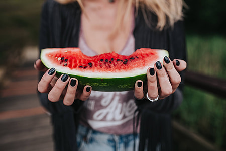 Blonde woman having a healthy snack at the wooden pier thumbnail
