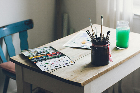 Paints and brushes on table thumbnail