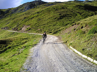 man riding bike in road at daytime thumbnail