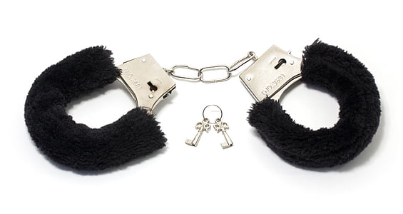 closeup photo of black and silver handcuffs with keys thumbnail