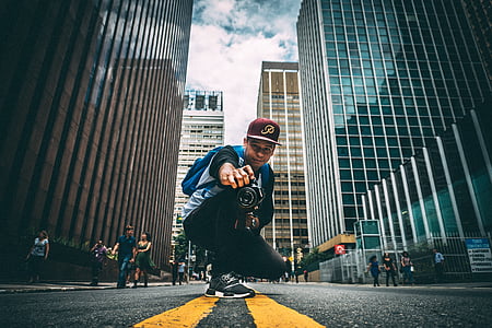 man holding DSLR camera thumbnail