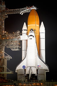 white and orange NASA Discovery space shuttle during nighttime thumbnail