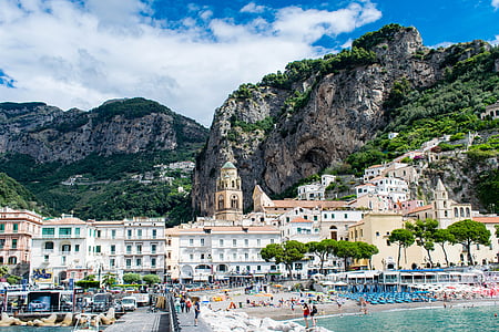 white and brown concrete buildings surrounded with mountain thumbnail