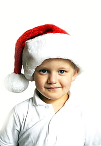 boy in white polo shirt and red Santa cap thumbnail