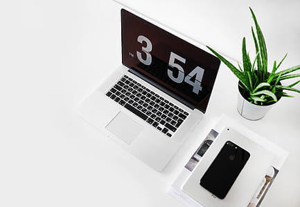 silver laptop computer beside aloe vera plant and iPhone 7 thumbnail