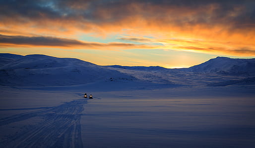 two snow mobile near mountain thumbnail