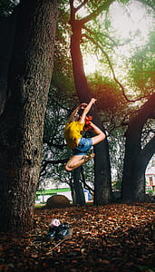 Person in Yellow Shirt and Blue Denim Shorts Doing Ballet Stance on Woods thumbnail
