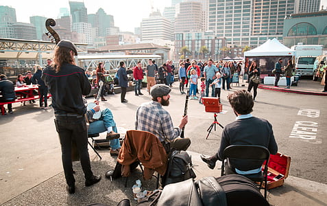 musicians playing musical instruments near crowd thumbnail